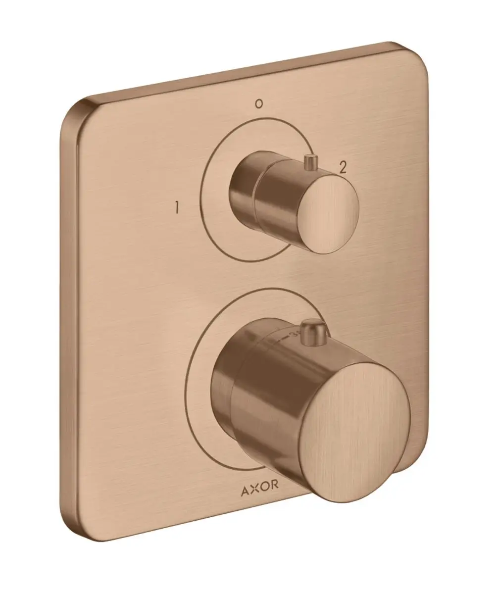 Thermostatunterputz von AXOR mit zwei Drehreglern auf einer rechteckigen Plattenoberfläche in Brushed Red Gold.